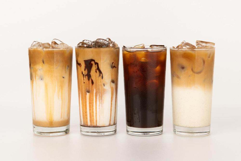 A Guide To Cold Brew Coffee featuring four stylish iced coffee drinks with ice and varying colors.