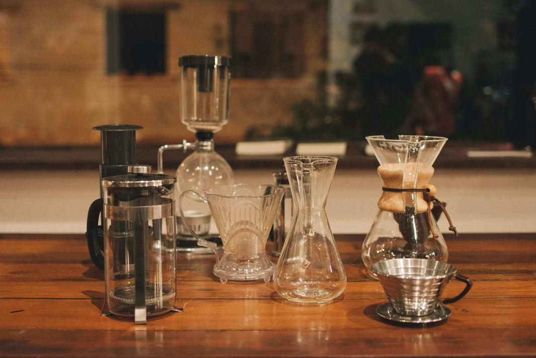 Unlock the Secrets of Brewing Coffee with various coffee brewing equipment on a wooden table.