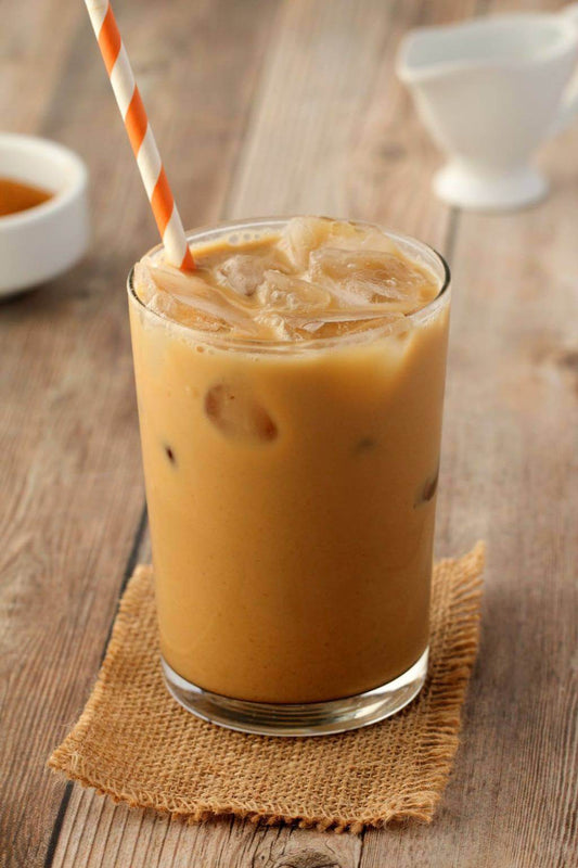 A refreshing glass of iced coffee, showcasing the perks of iced coffee with ice cubes and a straw.
