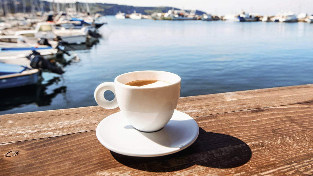 Chill Out: Discover the Surprising Summer Coffee Benefits You Might Be Missing - cup of coffee by the water.