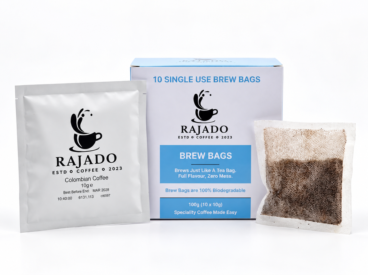 Rajado Colombian Coffee single-use brew bags shown with a silver foil packet, a blue-and-white retail box, and a brewed coffee bag on a clean white background.