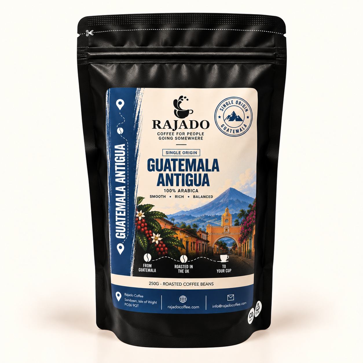 A black stand-up pouch of Rajado Coffee Guatemala Antigua single origin coffee beans, featuring a detailed label with a scenic image of Antigua Guatemala, blue and cream colors, and product details.