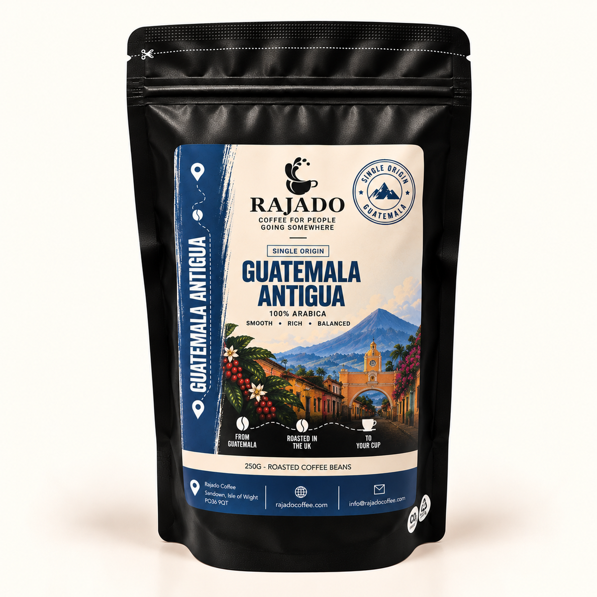 A black stand-up pouch of Rajado Coffee Guatemala Antigua single origin coffee beans, featuring a detailed label with a scenic image of Antigua Guatemala, blue and cream colors, and product details.