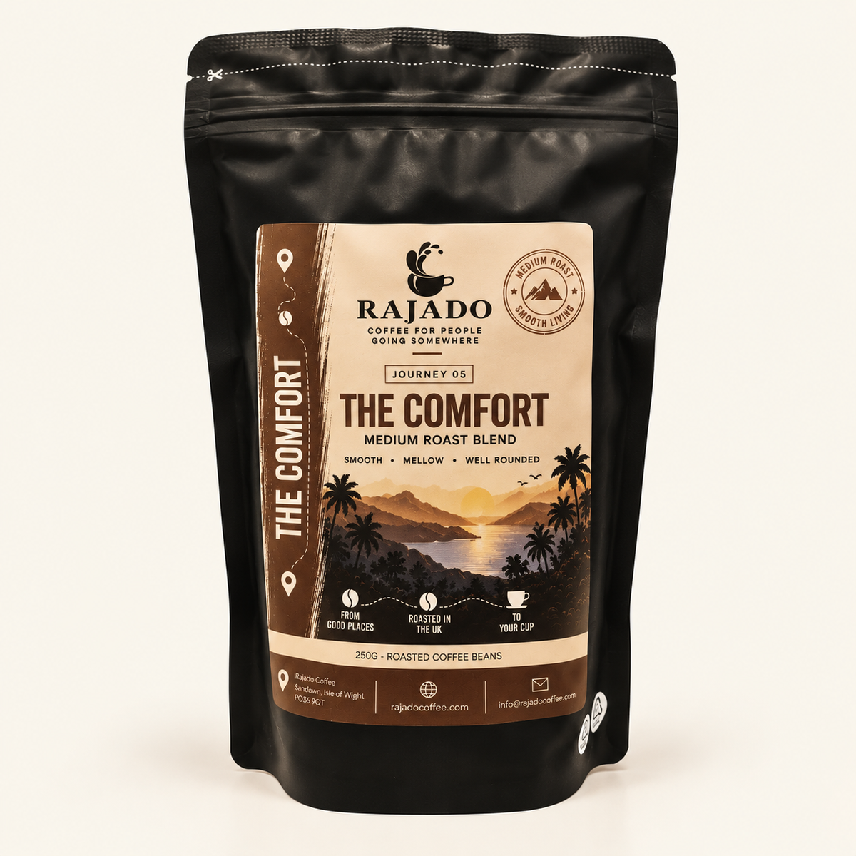 A black stand-up pouch of Rajado Coffee Roasters 'The Comfort' medium roast blend coffee beans, shown against a plain off-white background.